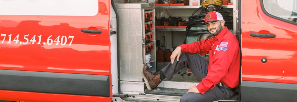 Moffett Plumber in front of work van
